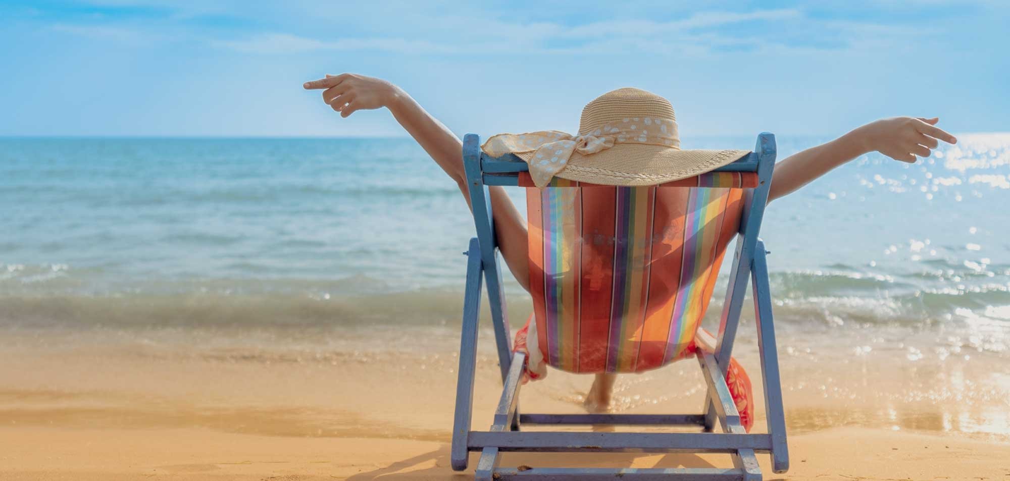 Woman sitting in a beach chair on a sunny beach